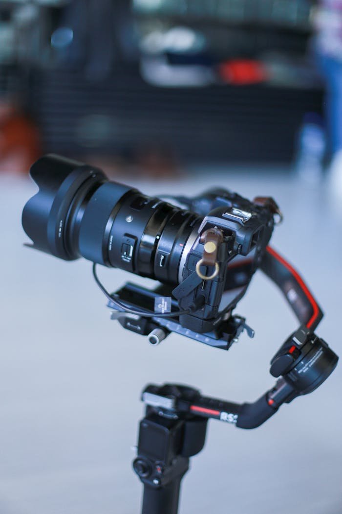 Close-up of a professional camera mounted on a stabilizer indoors, highlighting advanced filming technology.
